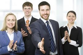 Businessmen and women reaching out in greeting