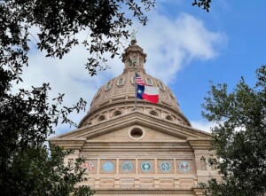The Texas capitol building with Texas flag waving out front