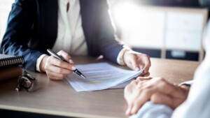 Commercial attorney completing paperwork with client
